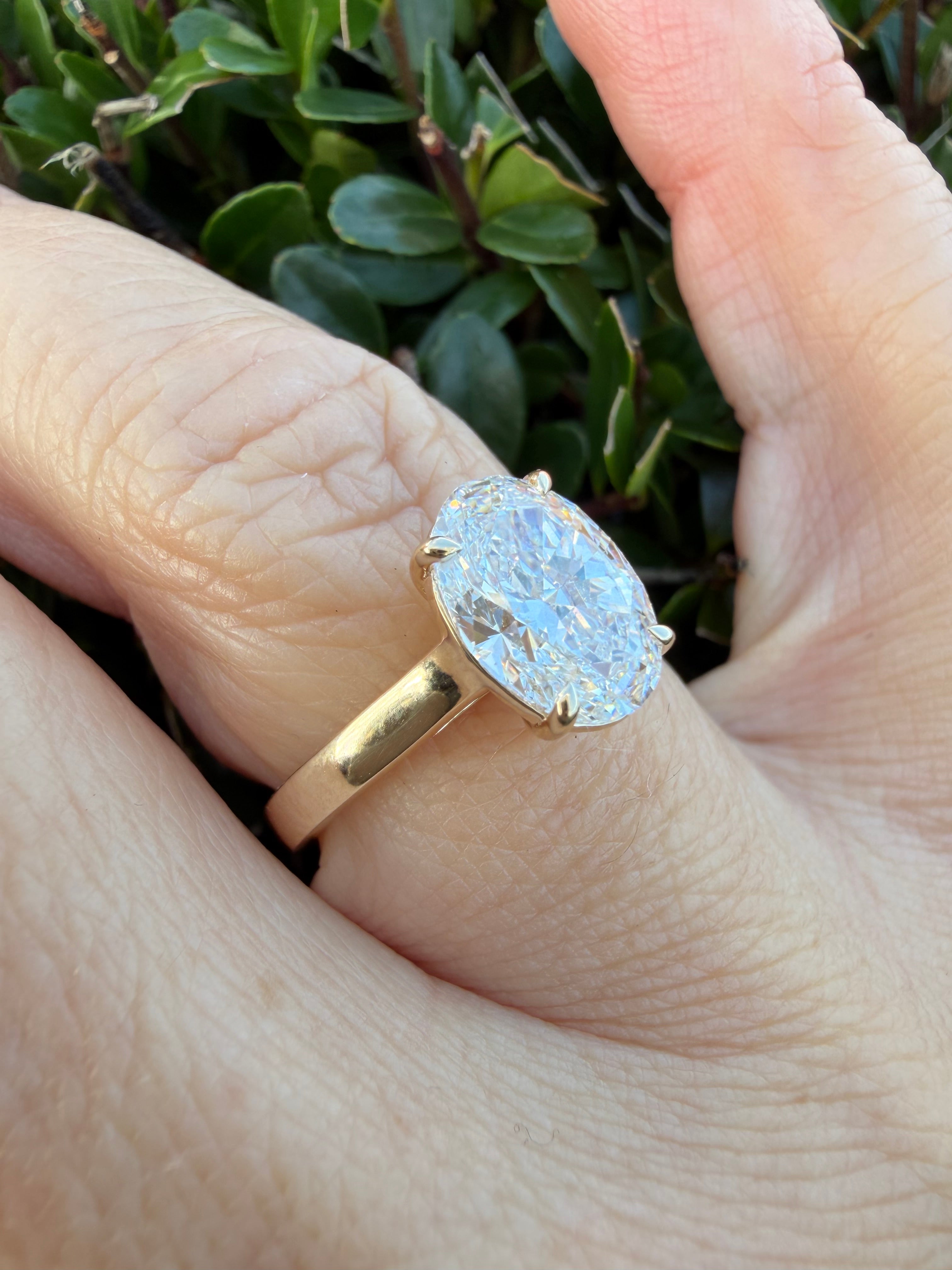 2.03ct oval cut Lab Grown Diamond Solitaire Ring IGI Certified set in 9k yellow gold