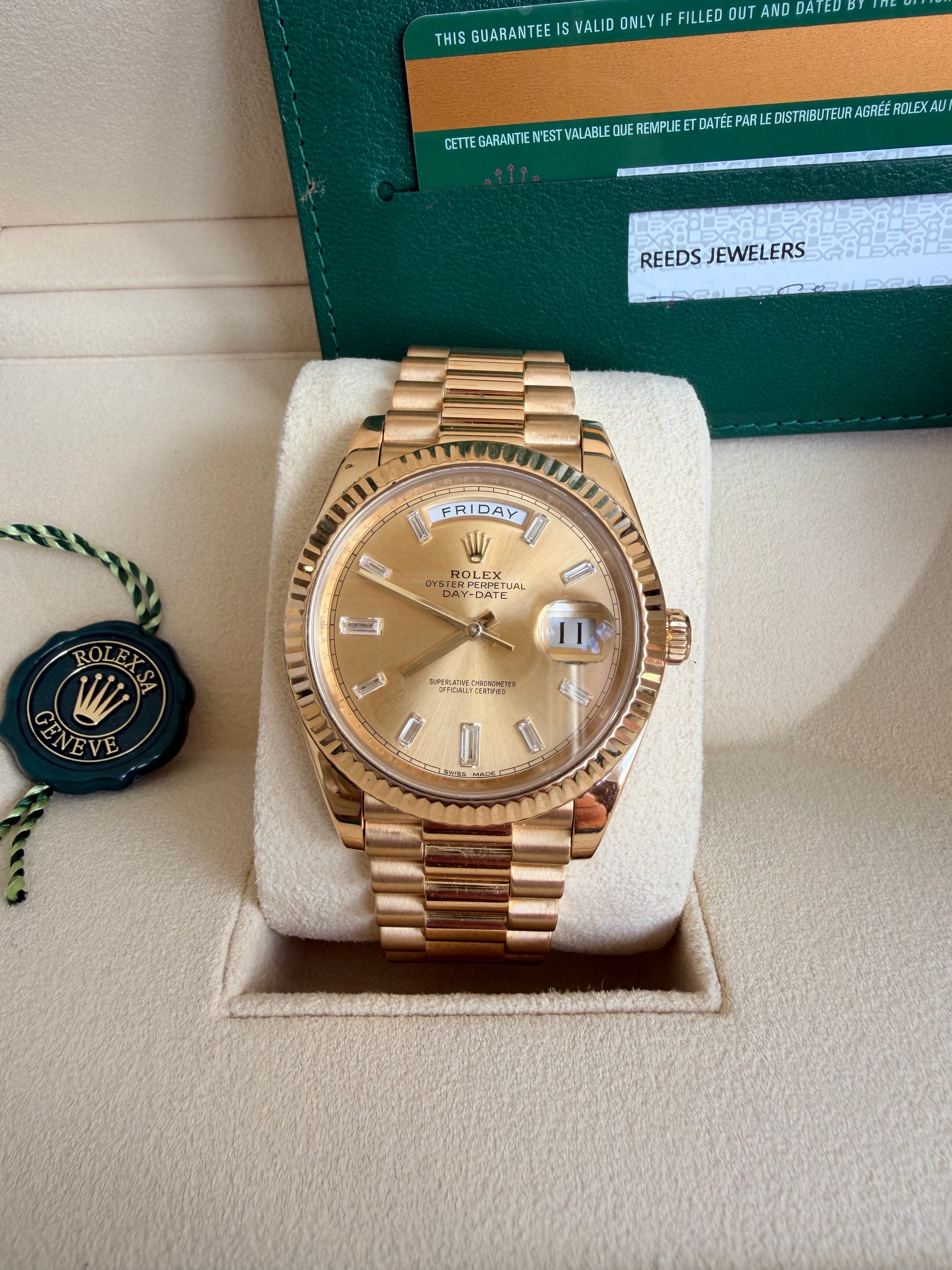 Rolex day date 18k yellow gold 228238 complete with B & P factory champagne baguette diamond dial 2020